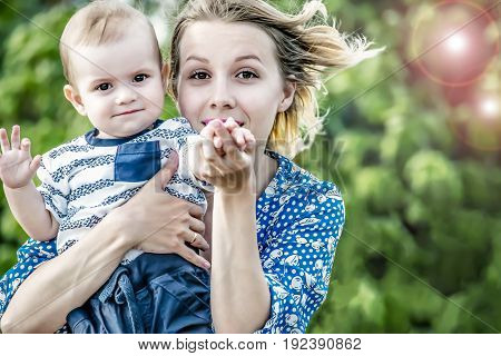 Beautiful happy mather with baby boy outdoor