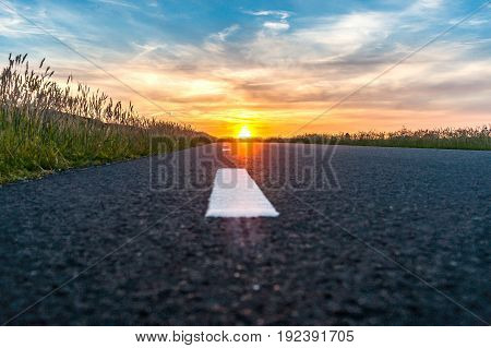 Sunset and lightning in beautiful countryside landscape along the road in the Netherlands.
