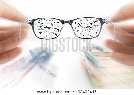 Two hands holding glasses use read book Education concept Magic glasses memory data concept Studying for exam