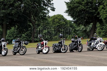 Sandhurst, Uk - June 18 2017: Row Of Motorcycles Left Parked In Front Of Parkland With Nobody Around