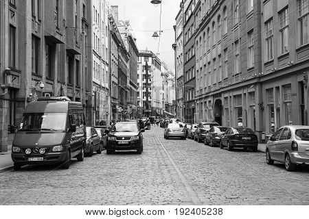People And Cars On Street In Old Riga Town