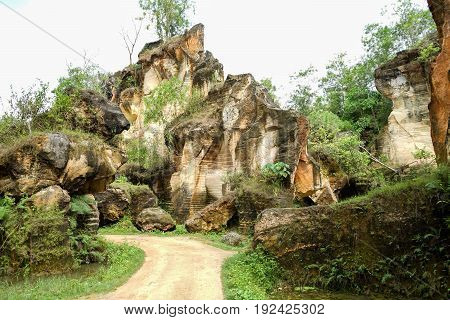 The exploitation of limestone hills canyon forming a unique architectural in Arosbaya Hill Madura Island, Indonesia