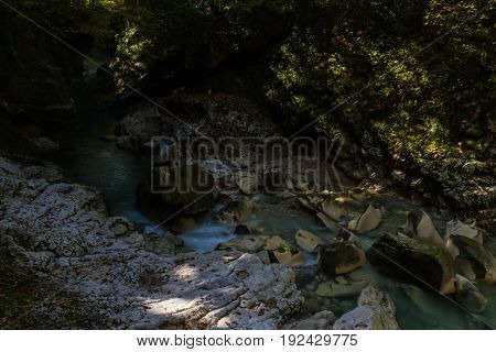Martvil Canyon Georgia Kutaisi. Blue river lakes with transparent water waterfalls canyon walls overgrown with moss.