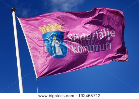 Sodertalje Sweden - April 12 2015: Close-up of the Municipality of Sodertalje flag against blue sky.