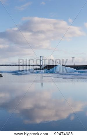 Reflcetion ligth over the lake with bridge crossing Iceland winter season natural landscape background