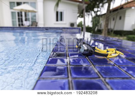 Goggles On The Side Of A Swimming Pool