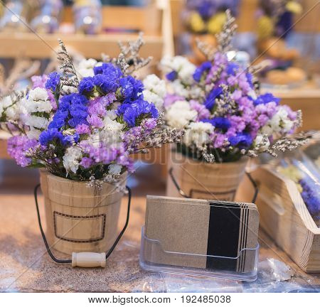 Colorful plastic flower and emty business card