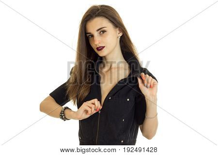 Cutie young woman with beautiful make up unbuttons a black jacket isolated on white background