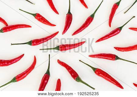 red hot chili peppers, popular spices, barbecue, food making concept - peppers filled white background, green tails, collage of freely lying peppers, top view, flat lay, horizontal