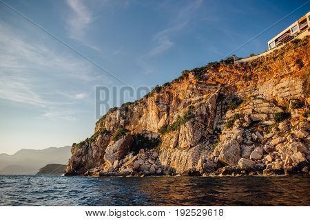Rocky coast of the Adriatic Sea in Montenegro at sunset, view from the sea