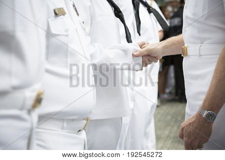 ADM Phil Davidson CDR US Fleet Forces Command gives challenge coins and handshakes to personnel at re-enlistment and promotion ceremony, National Sept 11 Memorial site Fleet Week NEW YORK MAY 26 2017