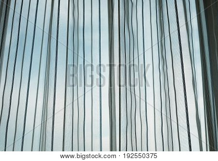 Window with texture curtain and blue sky