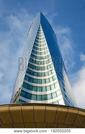 Early morning view from bottom of the skyscraper Tour EDF located in La Defense district Paris.