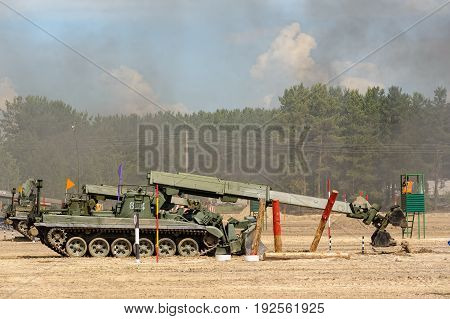 Tyumen, Russia - June 21, 2017: Army Games. Safe Route contest. Recovery of road part for column moving by IMR-2 combat engineer vehicle