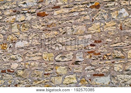 The Wall Built Of Irregular Stones Background. Texture Of Old Stonework. Space For Text. The Concept