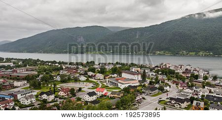 Panoramic view of Andalsnes city in Norway with mountains on background under a cloudy sky