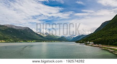 Panoramic view of Romsdalsfjorden and mountains from Andalsnes in Norway under a sunny sky