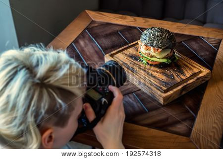 Woman food photographer shoots meal for restaurant