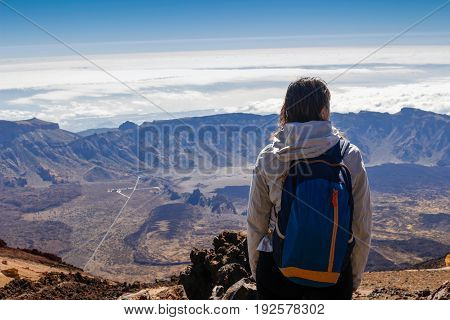 girl is watching the suggestive landscape from the teide volcan