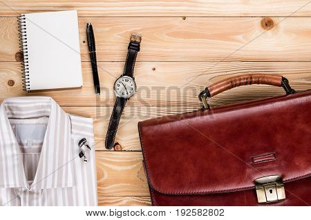 overhead view of business accessories and Businessman outfit on wooden background