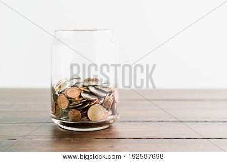 Coins and plant in glass business investment growth and saving concept.