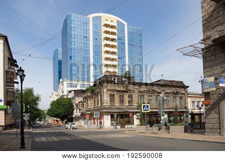 Rostov-on-Don Russia - June 182017: Ancient house with seedling trees at the intersection of the lane Semashko and street Serafimovich.The streets are pedestrian and the car is moving