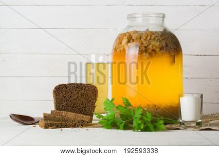 A Large Jar With Kvass Cooking. Black Bread And A Glass With A Drink.