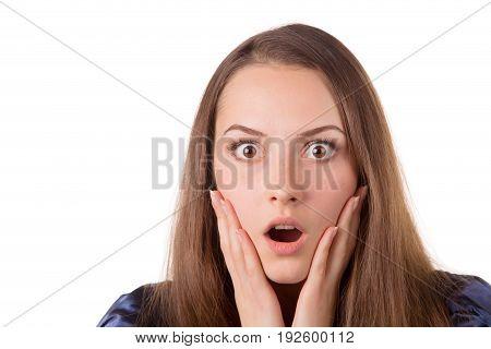 Headshot of a lady looking surprised with hands on her face.