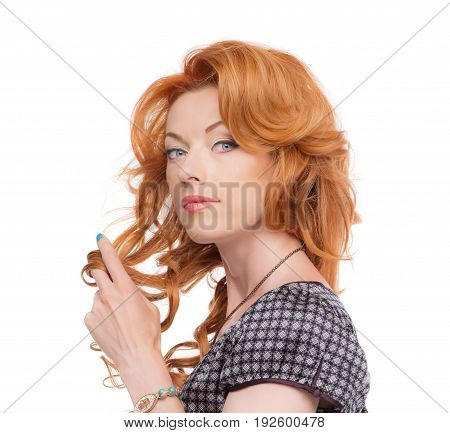 Headshot of a redhead in a grey dress.