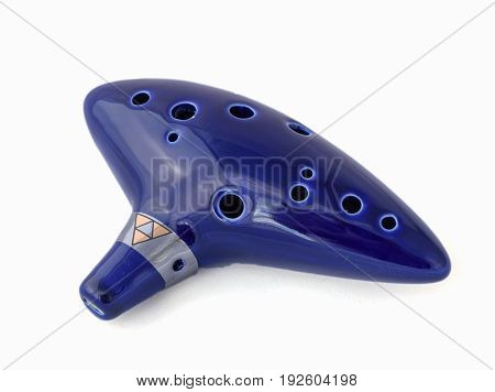 Ocarina flute blue color on white background isolate