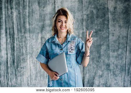 Lovely pretty girl with a laptop smiling and happy that she did the work on time