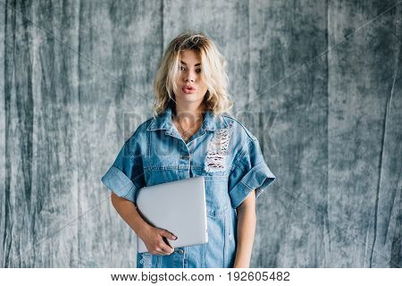 Lovely pretty girl with a laptop smiling and happy that she did the work on time