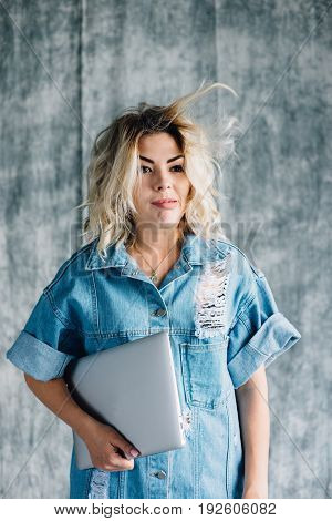 Lovely pretty girl with a laptop smiling and happy that she did the work on time