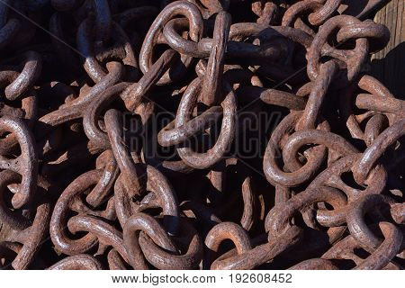 Large strong rusting chain with large links for marine use.