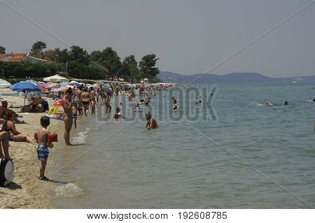 Chaniotis, Greece. June 24 2017: locals and tourists on the beach on a hot day.
Heatwave temperatures lead hundreds of people on the beach at Chalkidiki peninsula.