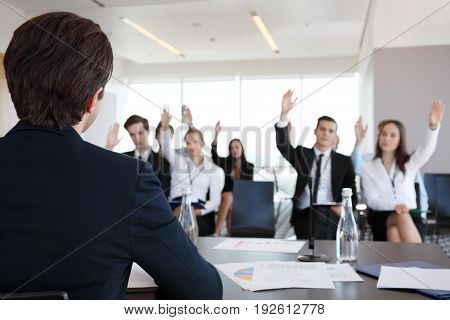 Speaker at business conference and audience asking questions