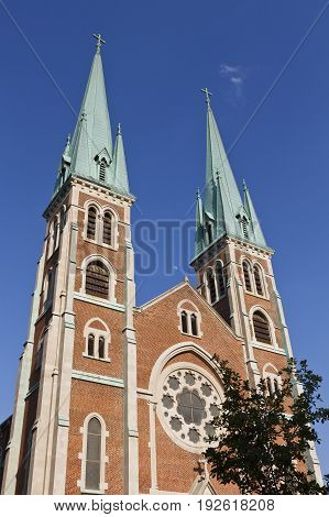 Two elegant church spires reaching toward a blue sky