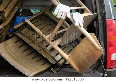Car boot loaded with old furniture cropped outdoor photo