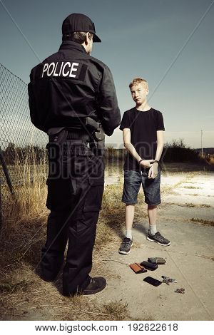 Police man catching youth pickpocket outdoor with three wallets