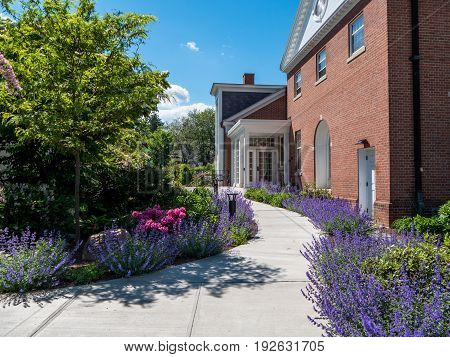 Brick building in Stockbridge massachusetts with path surrounded by flowers