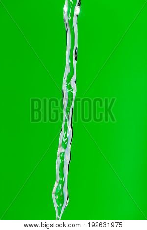 a jet of water on a green background