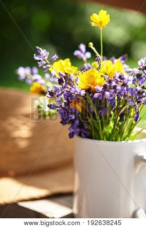 wild flowers and summer srtaw hat at sunny day