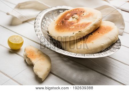 Kulcha is a type of leavened bread originated from the Indian Subcontinent; eaten in India and Pakistan, made from maida. Selective focus. Isolated