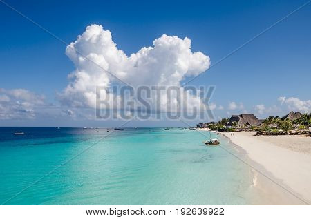 Nungwi Beach on Zanzibar Tansania. Seascape of the Indian ocean with boats and blue sky with clouds