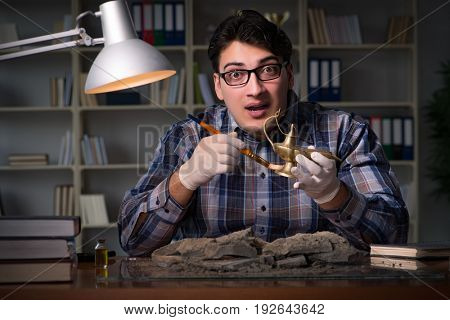 Archeologist working late night in office