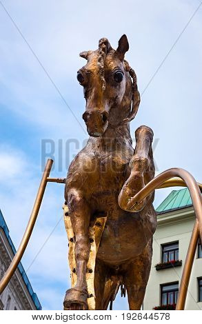 VIENNA, AUSTRIA - JUNE 06, 2017: The Golden Bucephalus, legendary horse of Alexander the Great,  installation by sculptor Andje Pietrzyk, located on Michaelerplatz in Vienna