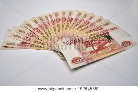 a lot of 5000 banknotes of Bank of Russia on white background Russian rubles spine 100 banknotes of five thousand rubles