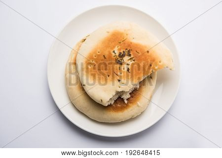 Kulcha is a type of leavened bread originated from the Indian Subcontinent; eaten in India and Pakistan, made from maida. Selective focus. Isolated