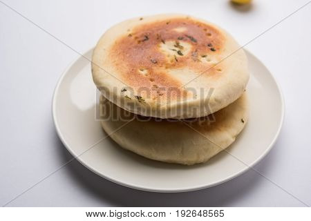 Kulcha is a type of leavened bread originated from the Indian Subcontinent; eaten in India and Pakistan, made from maida. Selective focus. Isolated