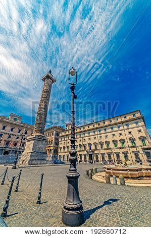 ROME ITALY - JUNE 1 2017: Column of emperor Marco Aurelio in Piazza Colonna with engraved the story of the campaign conducted by against the germans. Saint Paul bronze statue at the top.